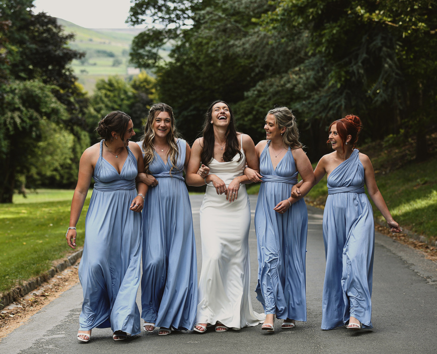 a Bride and her Brides Maids laughing in Durham, North East