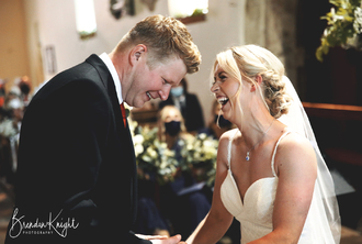 bride and groom laughing in church