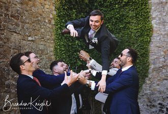 groom being thrown in the air