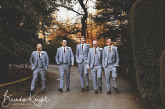 groom and grooms men walking and laughing 