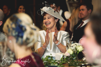 Mother of the groom smiling and clapping