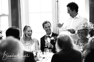 bride and groom at best mans speech